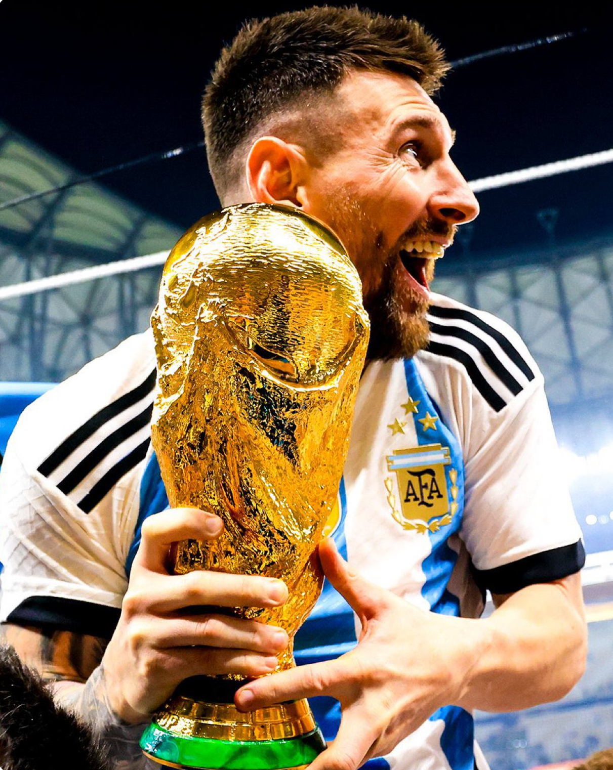 Lionel Messi holding the FIFA World Cup trophy with Argentina